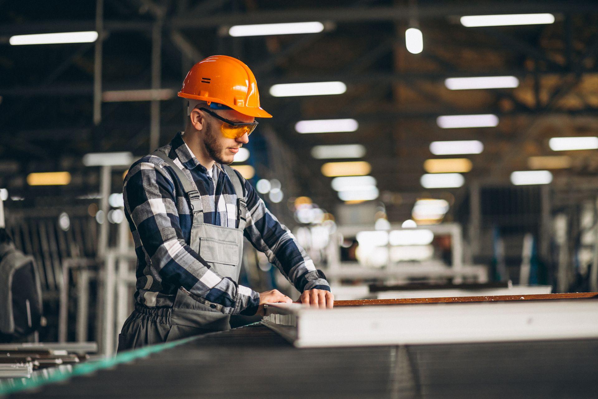 factory worker with orangehat as products are made
